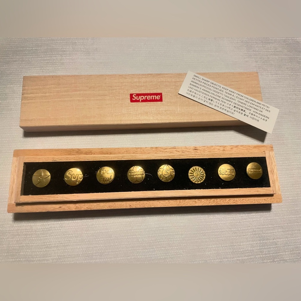 Supreme gold pins